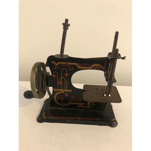 129 - Vintage Toy Child’s Sewing Machine With Vivid Painted Decoration Probably German
13 cms h x 13 cms w