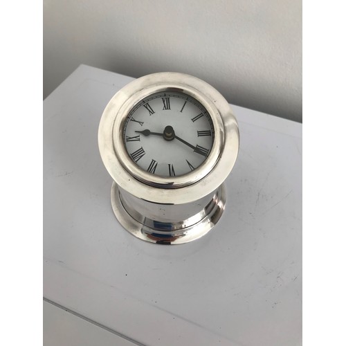 133 - Silver Plated Clock Case
9 cms high (rear) and 5 cms (front). 10 cms diameter