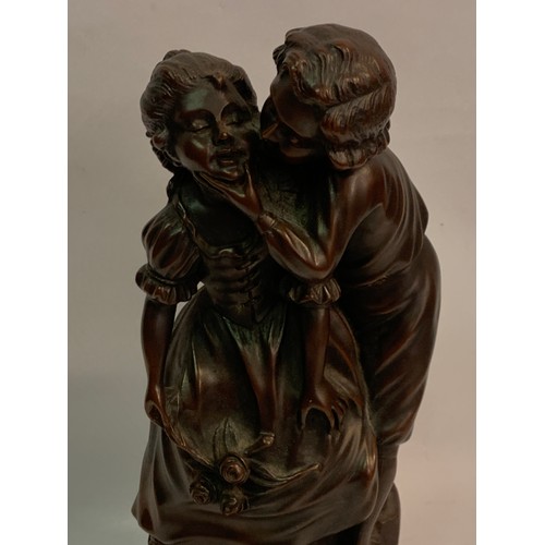 452 - Signed Bronzed Figure Of A Young Kissing Couple. 39 cms High