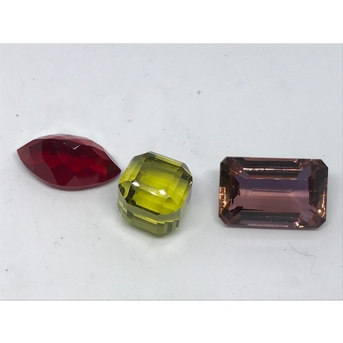 300 - Three Loose Gemstones With Certificates. 55.30 Yellow Cube Cut Topaz Along With A 61.30 Emerald Cut ... 