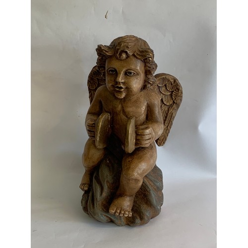 72 - Composite Seated Winged Cherub With Ceramic Eyes Standing 38 cms High