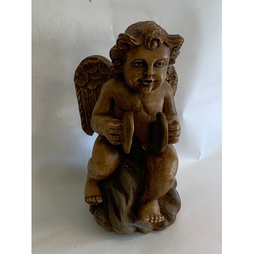 72 - Composite Seated Winged Cherub With Ceramic Eyes Standing 38 cms High