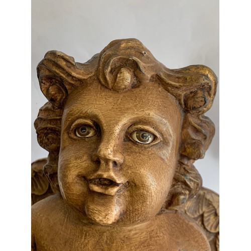 72 - Composite Seated Winged Cherub With Ceramic Eyes Standing 38 cms High