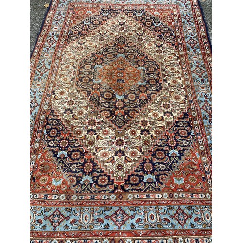 91 - Decorative Hand Tied Ground Rug With Central Pattern 254 x 165 cms