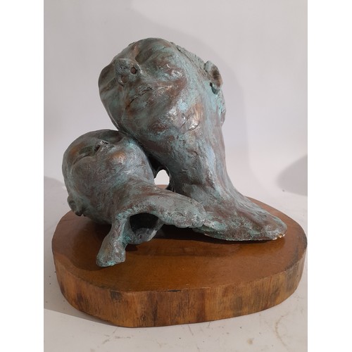 20 - Bronzed Plaster figure of mother and child sat loose on wooden base. 23cm high