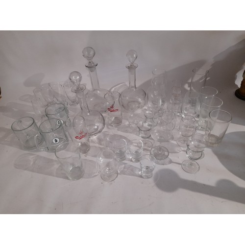 38 - Large quantity of glass to include 3 x decanters, glasses with advertising logos etc