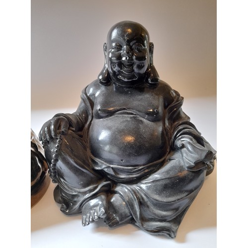 12 - 2 X Buddha Figures one in gold ceramic and the other in black resin. tallest 20cm x 18cm