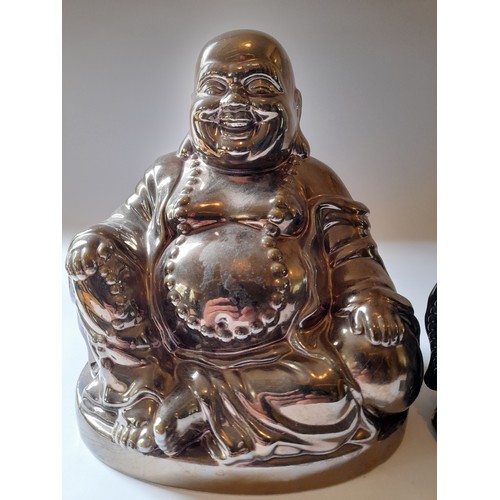 12 - 2 X Buddha Figures one in gold ceramic and the other in black resin. tallest 20cm x 18cm