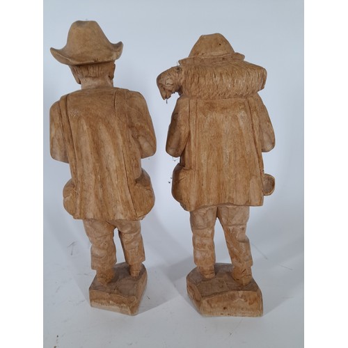 74 - Pair of wood carved figures standing 28cm high