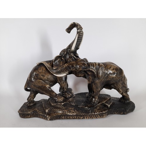 93 - Large ceramic display of 2 elephants tail broken on one and chip to trunk on the other. 36cm x 50cm