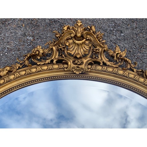 35 - Large Vintage Oval Gilt Decorated Mirror. 114 x 114 cms