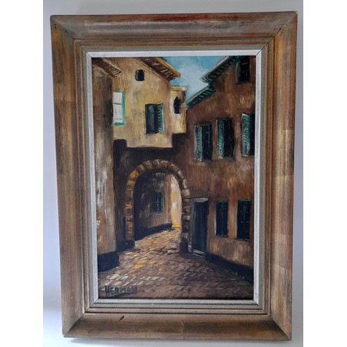 188 - Framed oil on canvas depicting a street scene signed lower left 75cm x 54cm