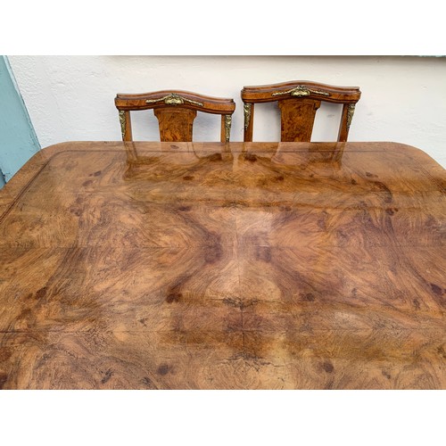 73 - French Walnut Veneer Art Deco Style Table And Six Chairs With Gilt Metal Adornments.