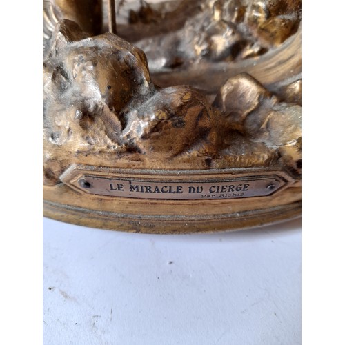 256 - Bronze/brass Le Miracle du Cierge, marked Depose France illiminated and musical. music box action wo... 