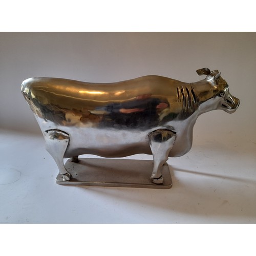 261 - Polished metal figure of a cow, 49cm x 27cm