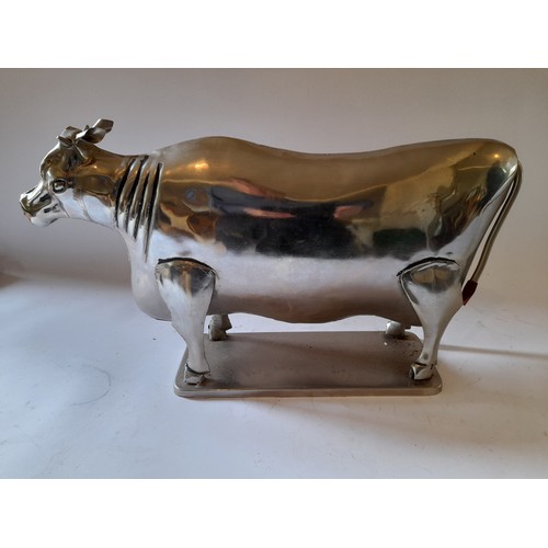 261 - Polished metal figure of a cow, 49cm x 27cm