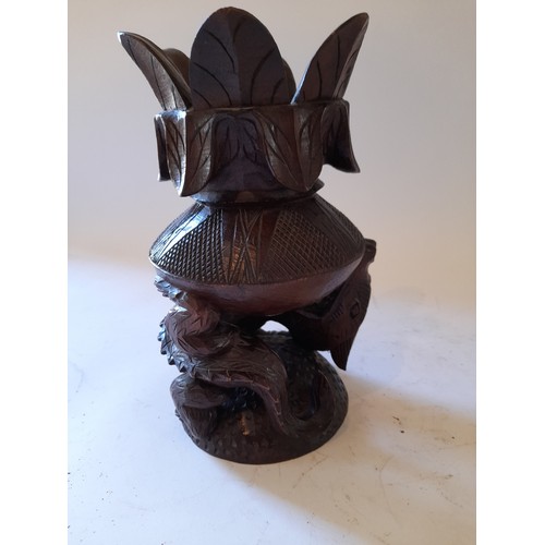 268 - Wood carved and turned decorative item in the form of a carved dragon holding up a flower