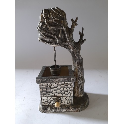 273 - Continental metal novelty table lighter in the form of a tree over a well with drawer under well con... 