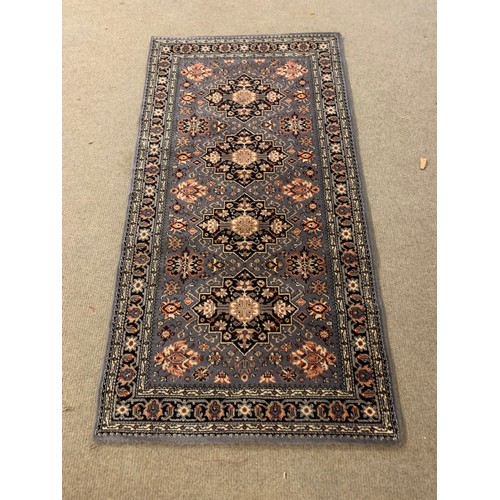 64 - Decorative Blue Ground Rug. 162 x 85 cms