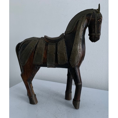 214 - Vintage Carved Wooden Statue Of A Horse Having Brass Copious Brass Adornments 
23 x 6 x 25 cms h