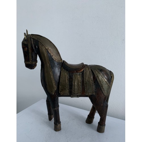 214 - Vintage Carved Wooden Statue Of A Horse Having Brass Copious Brass Adornments 
23 x 6 x 25 cms h