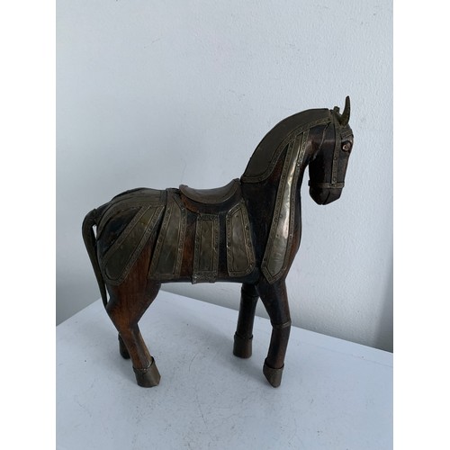 214 - Vintage Carved Wooden Statue Of A Horse Having Brass Copious Brass Adornments 
23 x 6 x 25 cms h