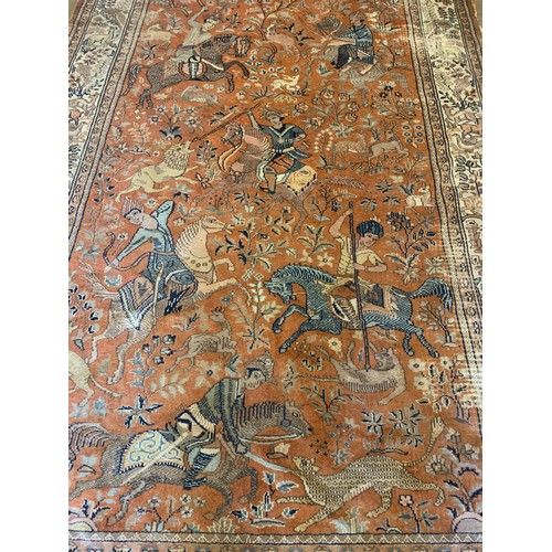 36 - Interesting ground rug with central hunting scenes from horse back 293cm 183cm