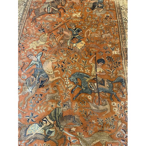 36 - Interesting ground rug with central hunting scenes from horse back 293cm 183cm