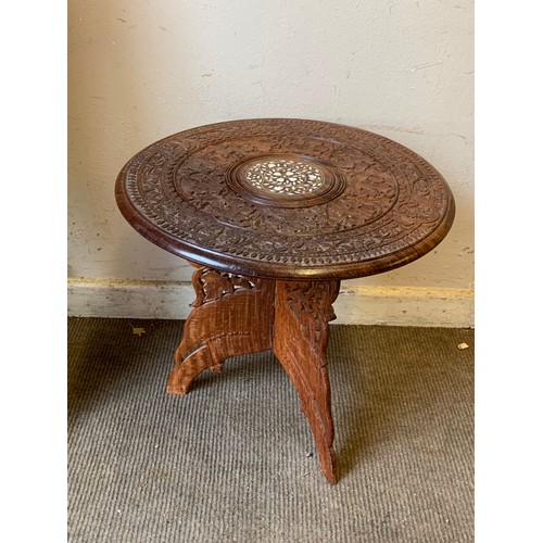 381 - Carved indian folding table 46cm dia x 46cm high