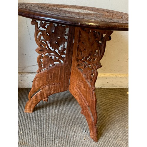 381 - Carved indian folding table 46cm dia x 46cm high