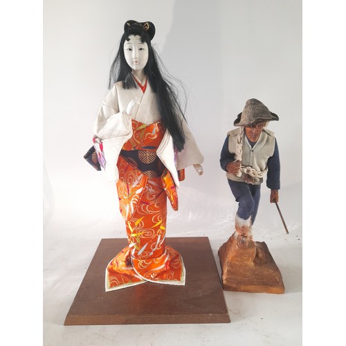 19 - 2 x figures mounted on wood base. 1 x Alpine Mountain Hiker 31cm high, the other of a Japanese lady ... 