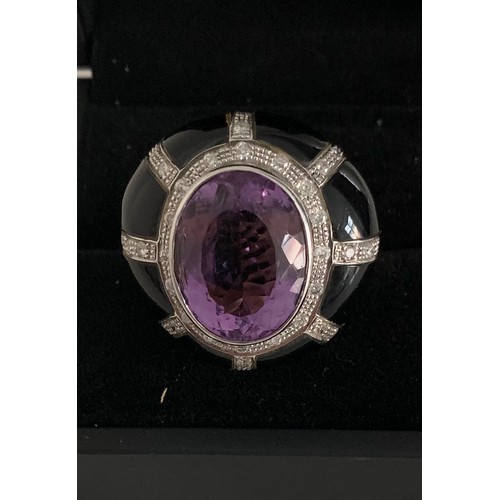 352 - 18ct Gold Ring Having A Large Amethyst In Jet With Diamond Decoration
15.6g. Size P