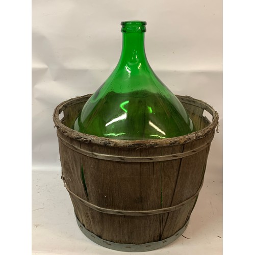 10A - Large Green Glass Demijohn / Carboy In A Wood Basket. 67 x 55 cms