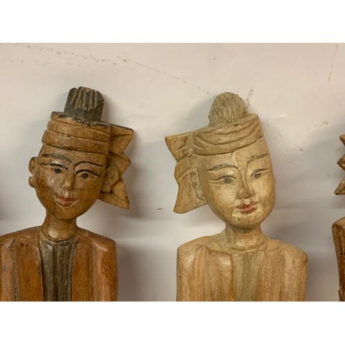 565 - Four Interesting Carved Wood Oriental Figures . 24 cms (4)