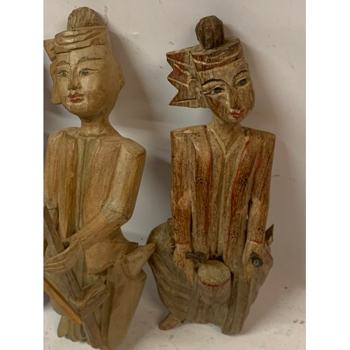 565 - Four Interesting Carved Wood Oriental Figures . 24 cms (4)