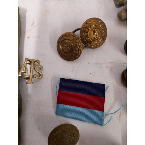 135 - Of Military interest, quantity of buttons, badges and a signed piece of uniform dated 1973