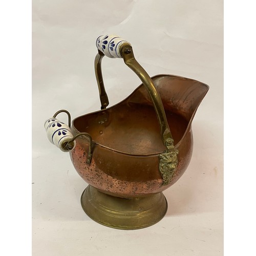 543 - Brass And Copper Coal Scuttle With Ceramic Handles And Lion Head Decoration.