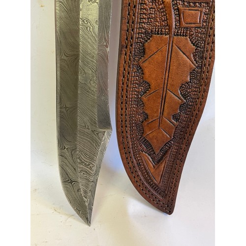 274 - Interesting Damascus Steel Bladed Bowie Knife Signed To The Hilt In A Tooled Leather Sheath. 41 cms