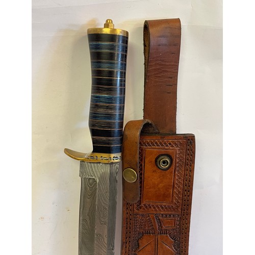 274 - Interesting Damascus Steel Bladed Bowie Knife Signed To The Hilt In A Tooled Leather Sheath. 41 cms