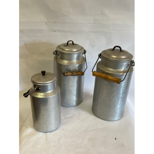 300 - Three Vintage Aluminium Lidded Milk Jugs. Largest 35 cms High (3)