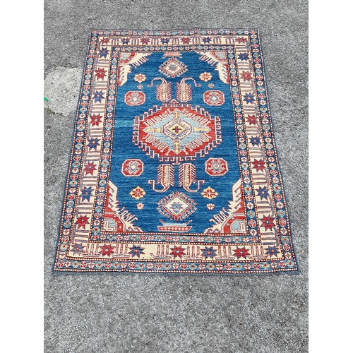 78 - Handmade Blue Ground Rug with central Lozenge and Flowers to Border, 195cm x 134cm