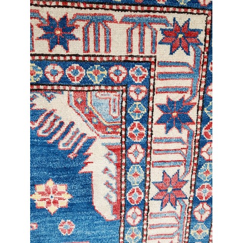 78 - Handmade Blue Ground Rug with central Lozenge and Flowers to Border, 195cm x 134cm