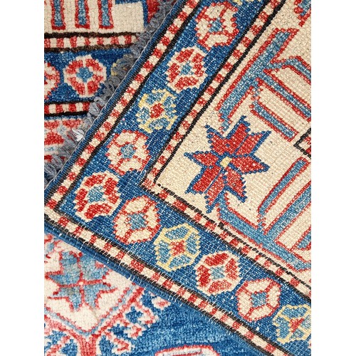 78 - Handmade Blue Ground Rug with central Lozenge and Flowers to Border, 195cm x 134cm