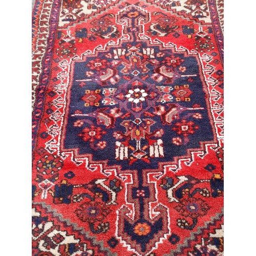 79 - Handmade Red Ground Rug with Central Lozenge, 160cm x 98cm