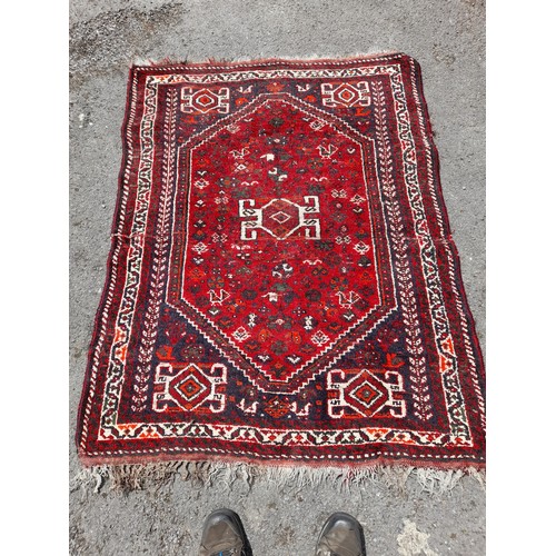 88 - Red Ground Handmade Rug with repairs, 148cm x 114cm