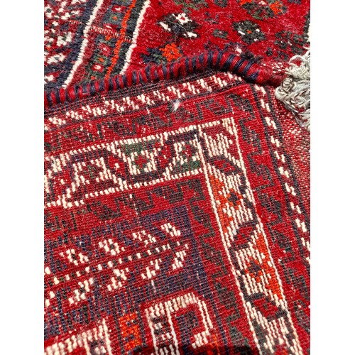 88 - Red Ground Handmade Rug with repairs, 148cm x 114cm