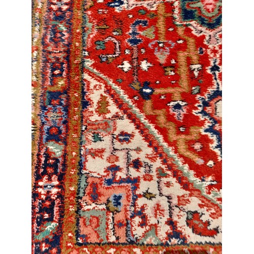 90 - Red Ground Rug Handmade with Blue Medallion to centre, 160cm x 90cm