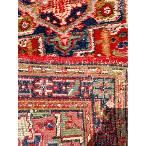 90 - Red Ground Rug Handmade with Blue Medallion to centre, 160cm x 90cm