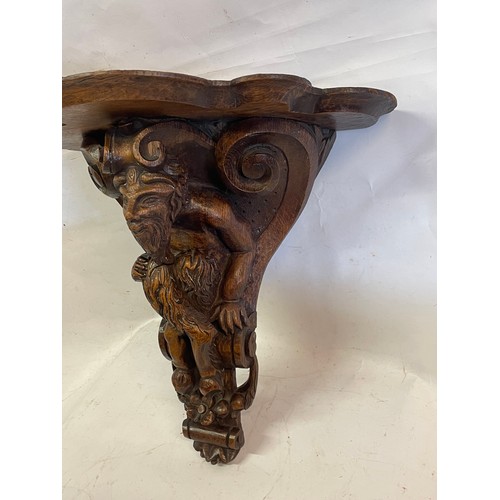 380 - 18th Century Carved Wood Bracket With A Carved Wood Figure Of A Faun.44 x 24 x 44 cms