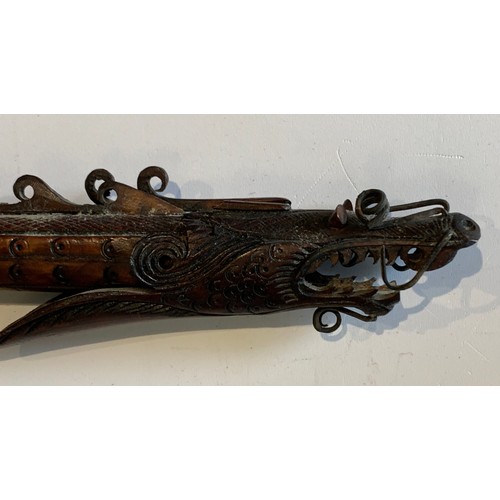 115 - Vintage Indonesian Carved Bone Blowpipe Depicting A Mythical Dragon Like Beast
77 cms in length